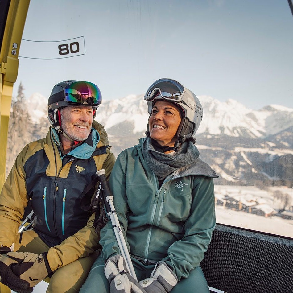 Skiers in the gondola lift